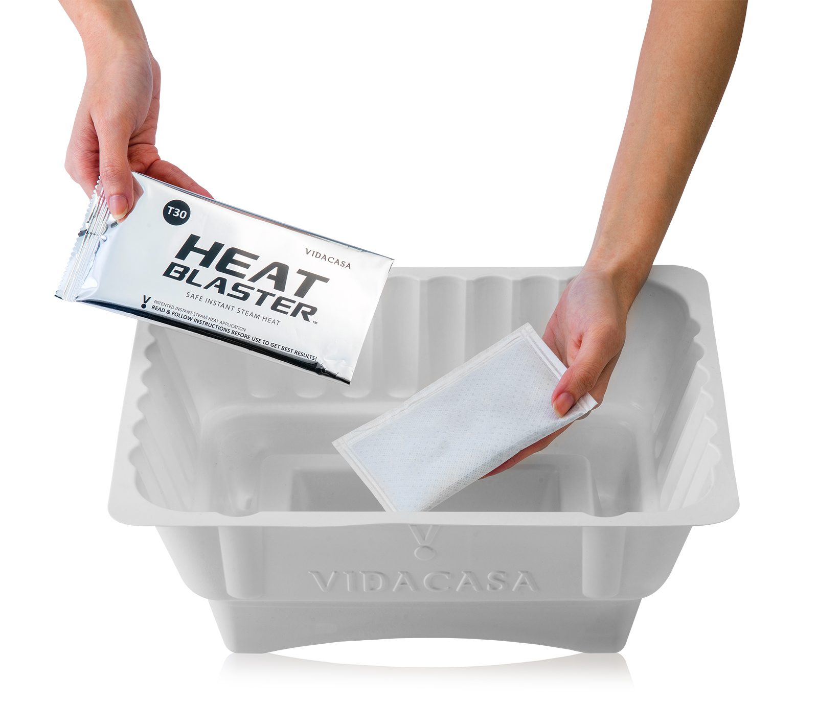 Hand dropping a T30 Heat Blaster pack into a white GN 1/2 base tray