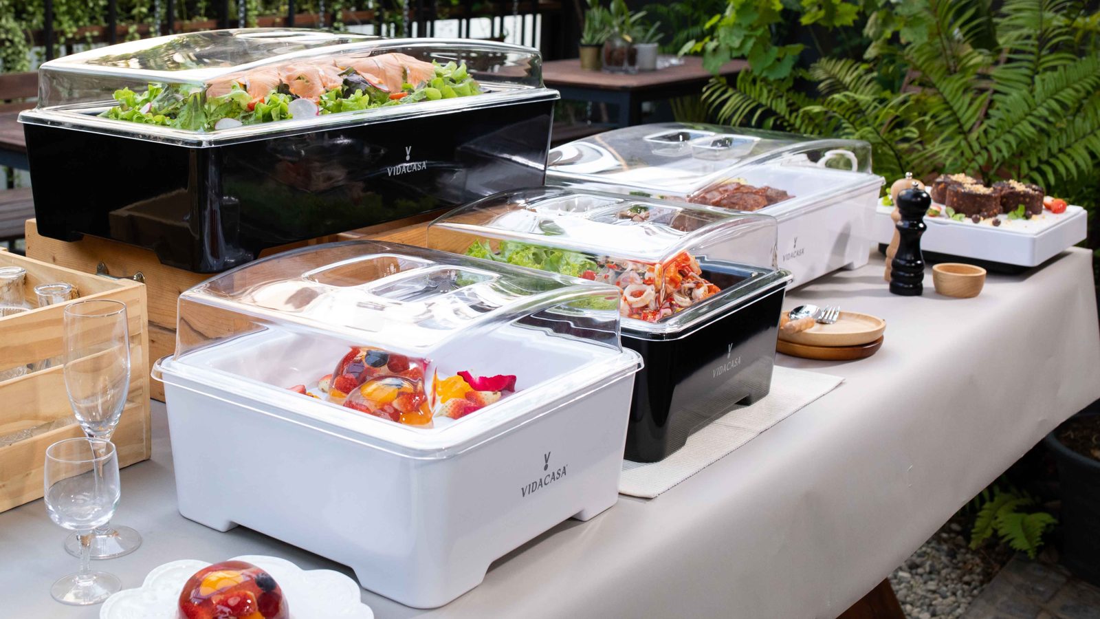 Classic buffet sets on an outdoor table with salad and meats