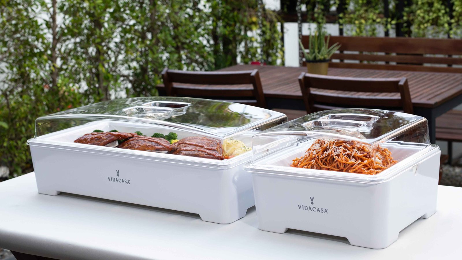 Classic buffetware sets with salad and roast meats on an outdoor terrace