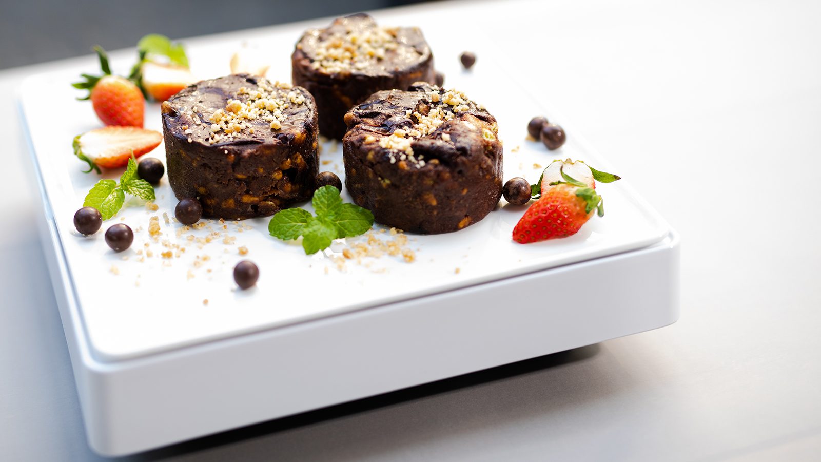 Chocolate desserts and strawberries chilled on a white S281 tabletop